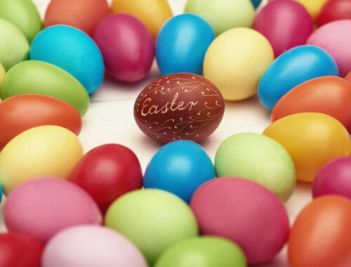 Brown easter egg among colorful ones