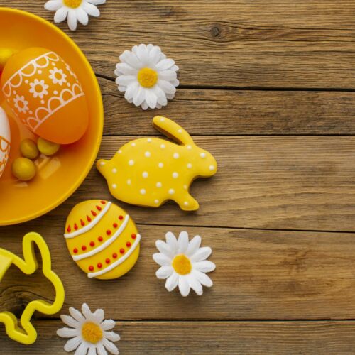 top-view-colorful-easter-eggs-plate-with-chamomile-flowers-copy-space
